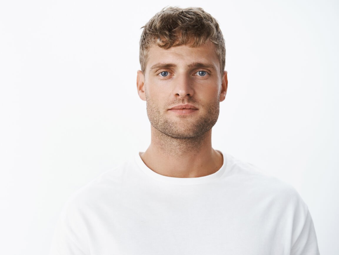 waist-up-shot-handsome-calm-blond-blue-eyed-guy-with-bristle-white-t-shirt-looking-front-with-relaxed-carefree-facial-expression-posing-gray-wall-looking-sincere-chill 1-1 waist-up-shot-handsome-calm-blond-blue-eyed-guy-with-bristle-white-t-shirt-looking-front-with-relaxed-carefree-facial-expression-posing-gray-wall-looking-sincere-chill 1-1